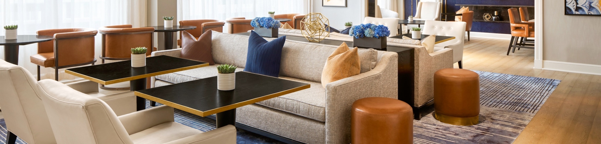 well lit lounge with with sofas and chairs