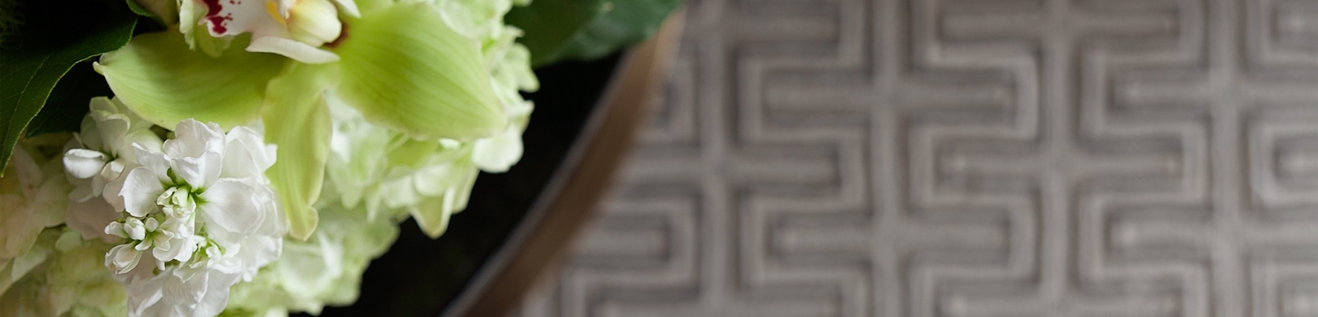 An aerial view of a table with a white and green floral arrangement.