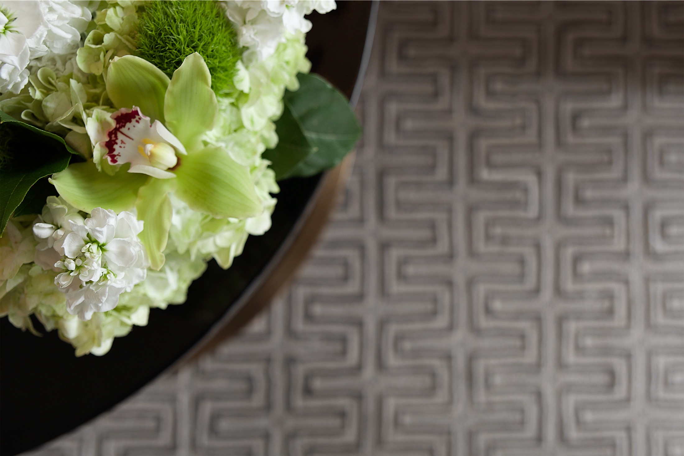 An aerial view of a table with a white and green floral arrangement.
