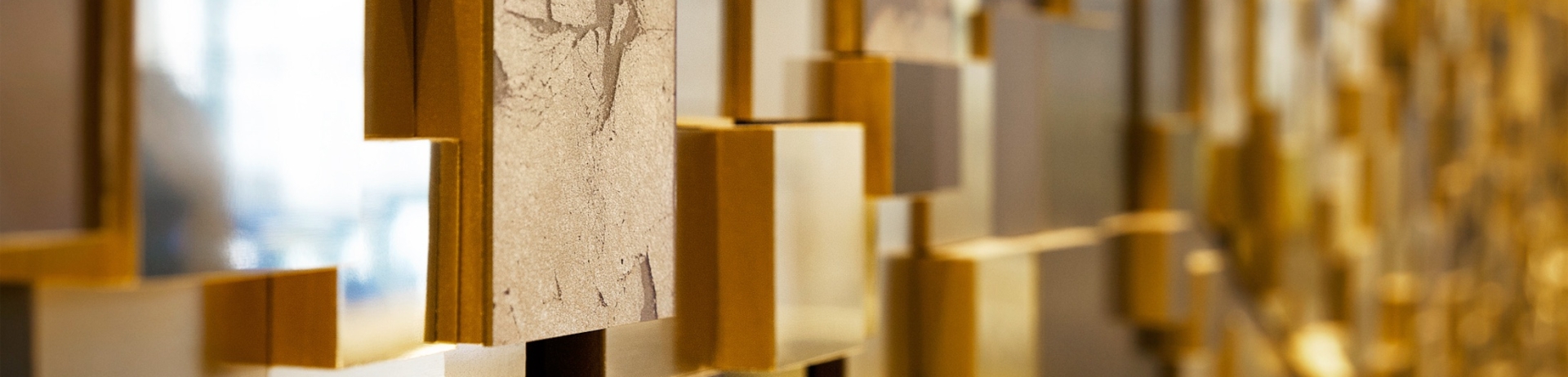 A decorative wall made out of gold geometric shapes.