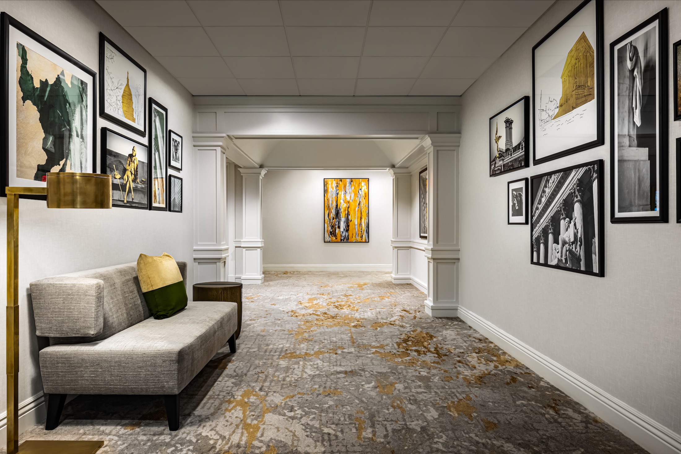 A room with a sofa and art hanging on the walls.