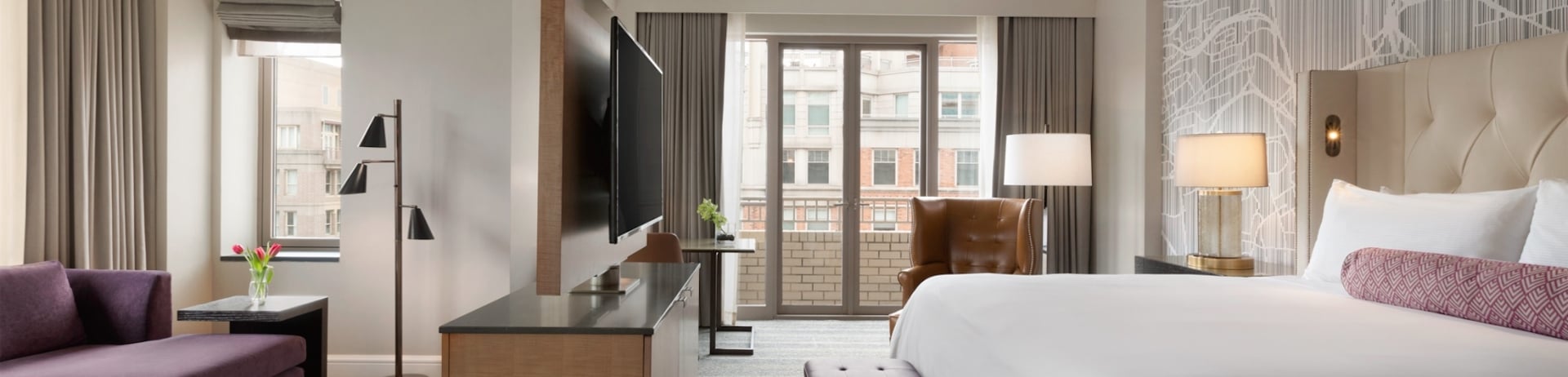 bedroom with large bed and television stand