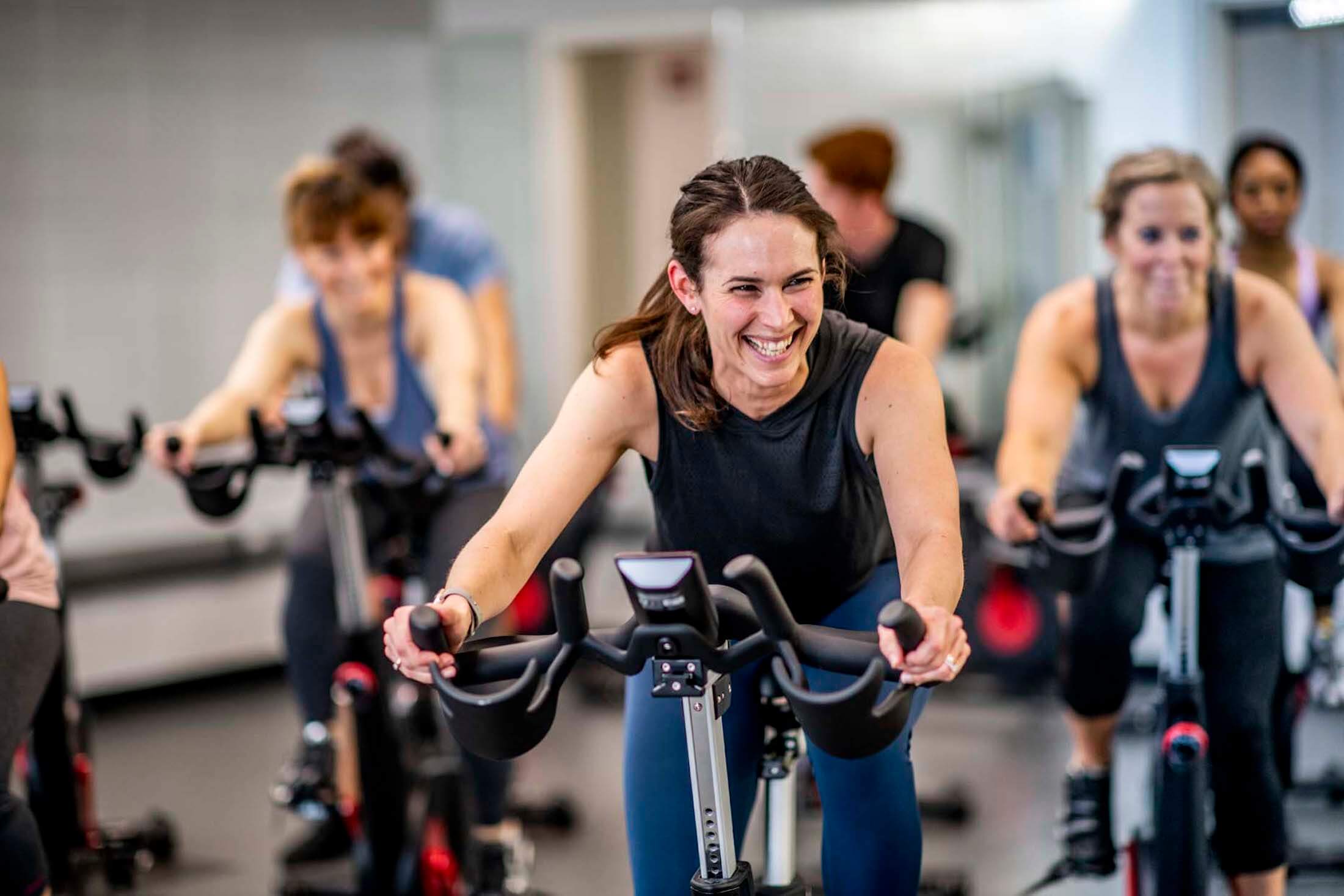 A group of women doing a spin class.